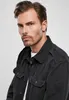 Close-up portrait of a man wearing a black shirt. Produktbild-Vorschau