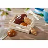 A wooden crate filled with toy baked goods, including a loaf of bread, croissants, and rolls, sits on a wooden table with a tea cup and saucer in the background. Produktbild-Vorschau