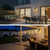 Two split images showing outdoor patio areas at night, illuminated by wall lights. Produktbild-Vorschau