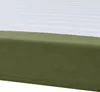 A close-up view of a bed frame with a green corduroy base and a white, striped mattress or duvet. Produktbild-Vorschau