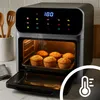 An air fryer oven with muffins inside, on a kitchen counter. Produktbild-Vorschau