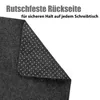 A close-up view of the underside of a dark gray desk mat, showing its non-slip texture. Produktbild-Vorschau