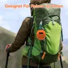 A person hiking with a backpack and a small orange speaker attached. Produktbild-Vorschau