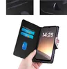 A hand holding a phone case with a phone inside, showing the phone's screen and the inside of the case with card slots. Produktbild-Vorschau