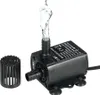 A black submersible water pump with water spraying from its outlet, shown with a detachable filter guard next to it, on a white background. Produktbild-Vorschau