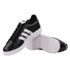 A pair of black Adidas sneakers with white stripes, shown from a side angle on a white background. Podgląd zdjęcia produktu