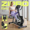 A woman is using a stationary bike in a room. There are inset images showing the bike's console and seat. Produktbild-Vorschau