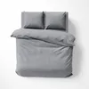 A top-down view of a gray striped duvet and two pillows on a bed. Produktbild-Vorschau