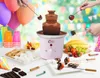 A chocolate fondue fountain set up for a party with balloons, cups, fruits, and s'mores ingredients. Náhľad obrázku produktu