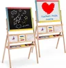 Two wooden easels with blackboards and whiteboards, displaying children's drawings and text. Voir les images du produit