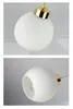 Close-up shots of a white glass globe pendant light with gold accents. Produktbild-Vorschau