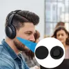 A man wearing headphones in an office environment, with a close-up inset of two black headphone ear covers. Náhľad obrázku produktu