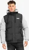 A man wearing a black puffer vest over a gray hooded sweatshirt. Anteprima dell’immagine prodotto