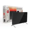 A black glass panel heater with silver legs is shown in front of its packaging. Produktbild-Vorschau