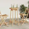 A bamboo bar table and two chairs set up on a patio with drinks on the table. Anteprima dell’immagine prodotto