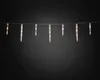 A string of icicle-shaped LED lights hangs against a dark background. Produktbild-Vorschau