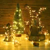 A festive arrangement of decorative windmills and a Christmas tree, all illuminated by warm white LED string lights. Produktbild-Vorschau
