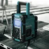 A Makita radio with a charger is placed on a wooden surface. Produktbild-Vorschau