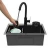 A hand is shown rinsing a plate in a black kitchen sink with a pull-down faucet. Podgląd zdjęcia produktu