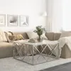A living room scene with a couch, coffee table, and artwork on the wall. Produktbild-Vorschau