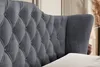 Close-up of a dark gray upholstered headboard with tufted detailing. Produktbild-Vorschau