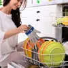 A woman is loading a dishwasher with colorful plates and cutlery. Produktbild-Vorschau