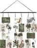 A collage of various safari-themed prints, including elephants, giraffes, zebras, and tropical foliage, arranged in a hanging display. Náhled obrázku produktu