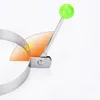 A close-up of a metal ring with a green handle, indicating its use for cooking. Produktbild-Vorschau