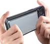 Hands holding a smartphone with a power bank attached to the back. Produktbild-Vorschau