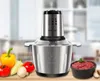 A stainless steel food processor is displayed on a wooden surface with fresh vegetables and minced meat in a bowl, set against a blurred kitchen background. Anteprima dell’immagine prodotto
