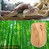 A split image showing a person carving a bamboo mouse and a close-up of a finished bamboo mouse against a bamboo forest background. Produktbild-Vorschau