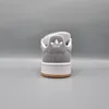 The back view of a gray Adidas sneaker with a white sole and a brown outsole, set against a plain gray background. Voir les images du produit