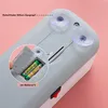 Close-up of the back of a device showing battery compartment, suction cups, and a power switch. Produktbild-Vorschau