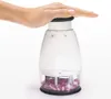 A hand pressing down on a manual food chopper filled with chopped red onions. Produktbild-Vorschau