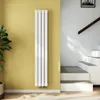 A modern interior scene featuring a vertical radiator against a yellow wall, with a staircase and railing in the background. Anteprima dell’immagine prodotto