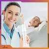 A dermatologist is holding a skin treatment device while a patient lies on a treatment bed in the background. Produktbild-Vorschau