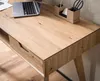 A close-up view of a wooden desk with a laptop and office supplies. Anteprima dell’immagine prodotto