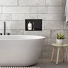 A modern bathroom with a freestanding bathtub, a built-in niche with toiletries, and a small stool with a plant. Podgląd zdjęcia produktu