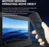 A hand holding a remote control in front of a curved TV screen displaying a seascape. Produktbild-Vorschau