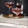 Two glasses of red wine on a tray next to a bottle of wine. Produktbild-Vorschau