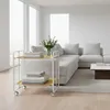 A modern living room with a sectional sofa and a serving cart. Anteprima dell’immagine prodotto