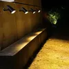 Outdoor solar lights illuminating a wall and pathway at night. Anteprima dell’immagine prodotto