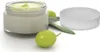 A cosmetic cream in a glass jar with its lid off, next to olives and leaves. Produktbild-Vorschau