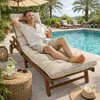 A man relaxing on a lounge chair by a swimming pool. Produktbild-Vorschau
