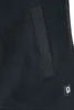 A close-up view of a black fleece jacket, showing a pocket and a small logo. Produktbild-Vorschau