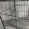 A close-up view of a large black bird cage with multiple shelves. Náhled obrázku produktu