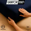 Hands are shown touching a dark blue fabric, likely a bedsheet, with a wooden surface in the background. Logos and text indicating product features are present. Produktbild-Vorschau