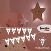 A child's bedroom with a star-shaped night light and decorative banners. Náhled obrázku produktu