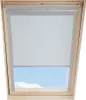 A close-up view of a white roller blind partially covering a skylight, with a blue sky and clouds visible below. Produktbild-Vorschau
