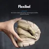 A hand is shown bending a beige shoe to demonstrate its flexibility. Produktbild-Vorschau